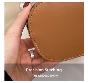 Close-up of precision stitching and textured brown leather on a leopard bucket bag