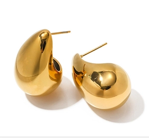 Detailed view of polished 18K gold-plated teardrop earrings with a glossy mirror finish