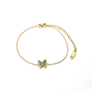 Elegant gold stainless steel butterfly bracelet with blue zircon stones on white background