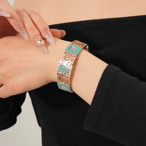 Detail of vintage bohemian elastic bracelet featuring colorful enameled square metal links