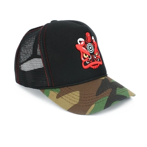 Detail of embroidered lion head on a trucker hat with camo brim and red contrast stitching
