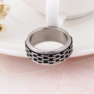 Close-up of vintage silver rotatable chain ring with industrial textured surface