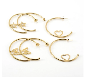Detailed close-up of gold stainless steel earrings with heart, star, and butterfly charms