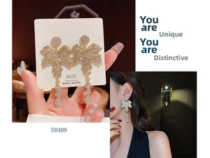 Detailed close-up and model view of gold maple leaf drop earrings with sparkling crystals