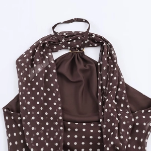 Detail view of the brown polka dot halter neck top with chiffon fabric and neck ties