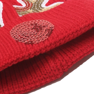 Kids red knit Christmas hat with deer antlers and shiny sequins for winter warmth