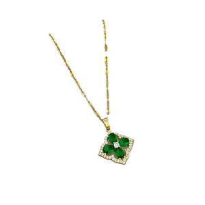 Luxurious gold clover necklace featuring green gems and pavé zircon settings
