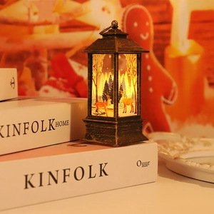 Detail of vintage Christmas lantern featuring a reindeer forest scene with warm LED light