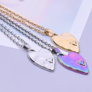 Three stainless steel heart pendant necklaces in gold, silver, and rainbow finishes