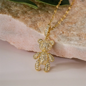 Close-up of golden bear pendant necklace with sparkling micro-pave zircons and fine chain
