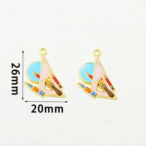 Detail shot of enamel stationery charms with dimensions 26mm by 20mm for DIY jewelry
