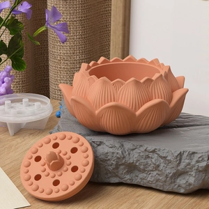 Macro detail of terracotta lotus candle holder mold showing textured petals and lid