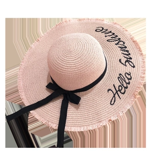 Pink straw sun hat featuring Hello Sunshine embroidery and a black ribbon bow detail