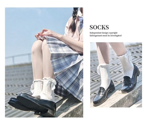 Detailed view of white calf socks featuring bow accents and elegant lace cuffs