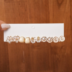 Detailed set of floral and pearl earrings with vintage gold metal frames and acrylic resin