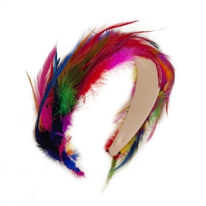 Colorful feather headband for women with vibrant plumes on a beige textured base