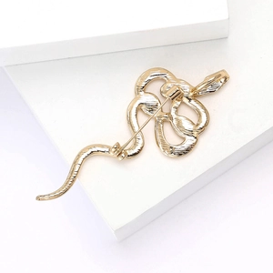 Detailed back view of the golden snake brooch showing the sturdy pin and clasp mechanism
