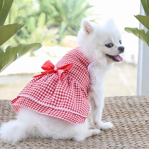 Detail of red and white checkered pet dress featuring a large red satin bow and pearls