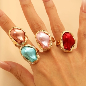 Set of four irregular gold rings with colorful enamel finishes worn on female fingers