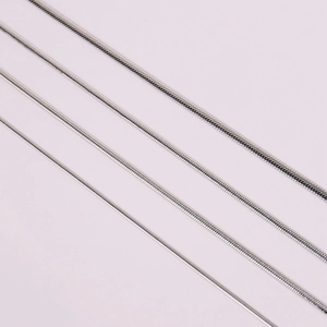 Macro shot showing four varying thicknesses of polished stainless steel snake chains