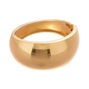 Modern wide gold metallic hinged cuff bracelet featuring a minimalist irregular geometric design