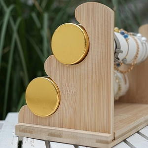 Three-tier bamboo jewelry display stand with golden end caps for bracelets and watches
