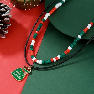 Detail of Christmas beaded necklace with Merry Christmas money bag pendant and pine cones