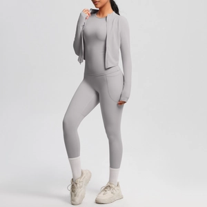 Detailed view of grey three-piece yoga set with zip jacket and high-waist leggings