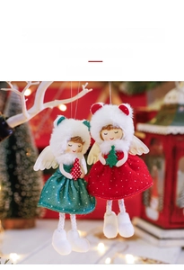 Macro shot of cute plush Christmas angel dolls in red and green polka dot outfits