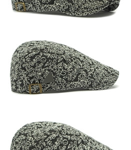 Detailed view of floral jacquard fabric and bronze metal buckle on retro flat cap