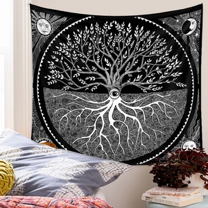 Detail of tree of life tapestry with sun and moon patterns in a cozy bedroom setting