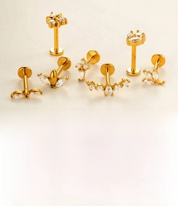 Detailed view of 7-piece gold labret set with marquise zircon and flower motifs