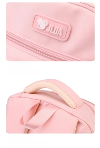 Close-up of the durable pink nylon fabric, stitched brand logo, and reinforced handle