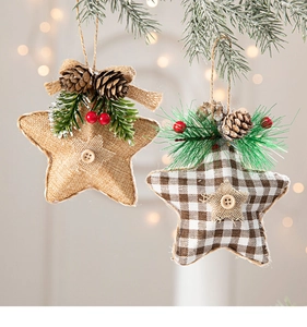 Detail of burlap star ornaments with pine cones and berries on Christmas tree branches
