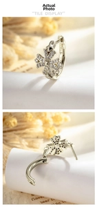 Detail of silver cross hoop earring with cubic zirconia and hinge closure mechanism
