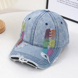 Distressed light blue denim baseball cap with colorful patches and ripped details