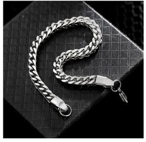 Silver stainless steel Cuban chain bracelet on black textured gift box with lobster clasp