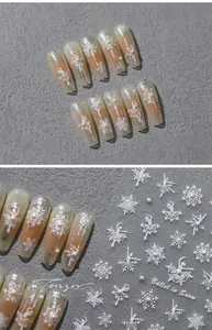 Detailed view of nude gradient nail art featuring snowflake motifs and ballet dancer accents