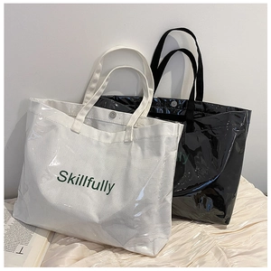 Detail of white and black waterproof PVC tote bags with Skillfully text on canvas