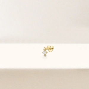 Detailed macro view of S925 silver gold-plated heart stud with square zircon stone