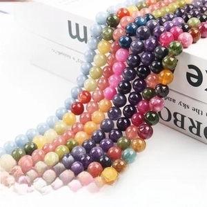 Close-up of assorted natural eagle eye and gemstone round beads for jewelry making