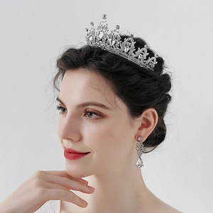 Luxury silver bridal tiara and earrings set with sparkling crystals on a female model