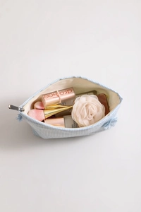 Detailed view of blue gingham makeup bag with tassel zipper and soft cotton fabric