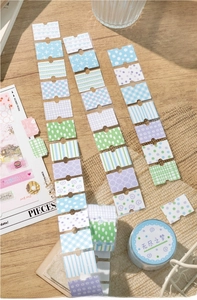 Macro detail of floral washi tapes with pastel geometric patterns for scrapbooking