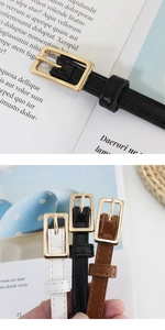 Detailed close-up of slim waist belts with golden square buckles in black, white and brown