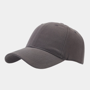 Detail view of the dark grey cotton canvas fabric and curved brim of the baseball cap