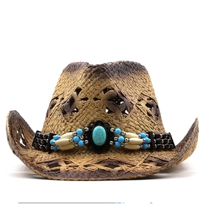Detail of woven straw cowboy hat with turquoise centerpiece and decorative beads