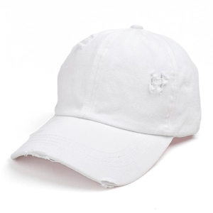 Close-up of distressed details and frayed edges on a white washed cotton baseball cap