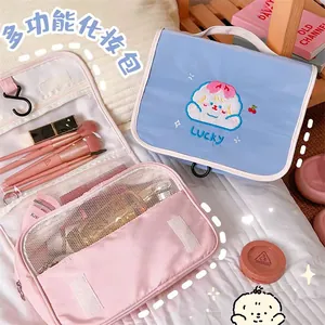 Detail of portable makeup bag with cute embroidery, hanging hook and mesh pockets