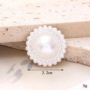 Close-up of a 2.2cm pearl charm with silver rim for shoes and phone case DIY decor